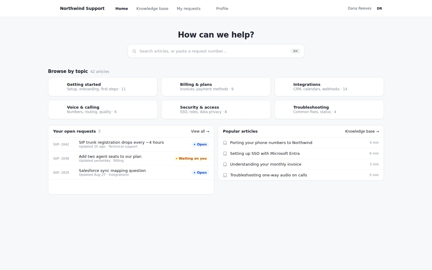 A customer support portal: search, browse by topic, and the customer's open requests